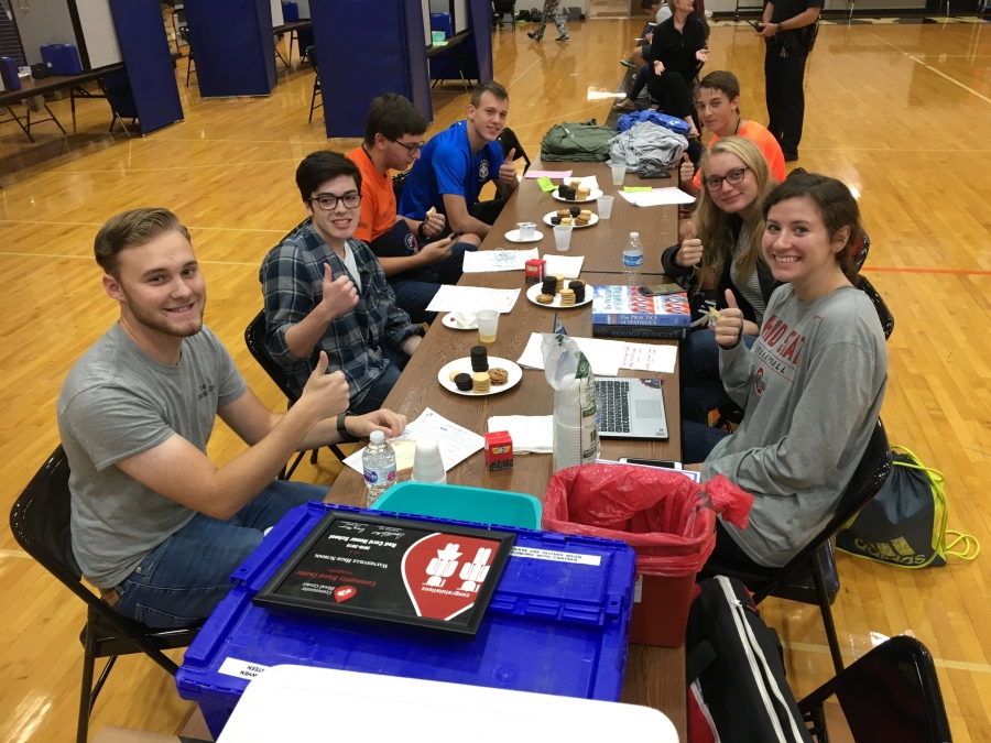 people at a table having cookies